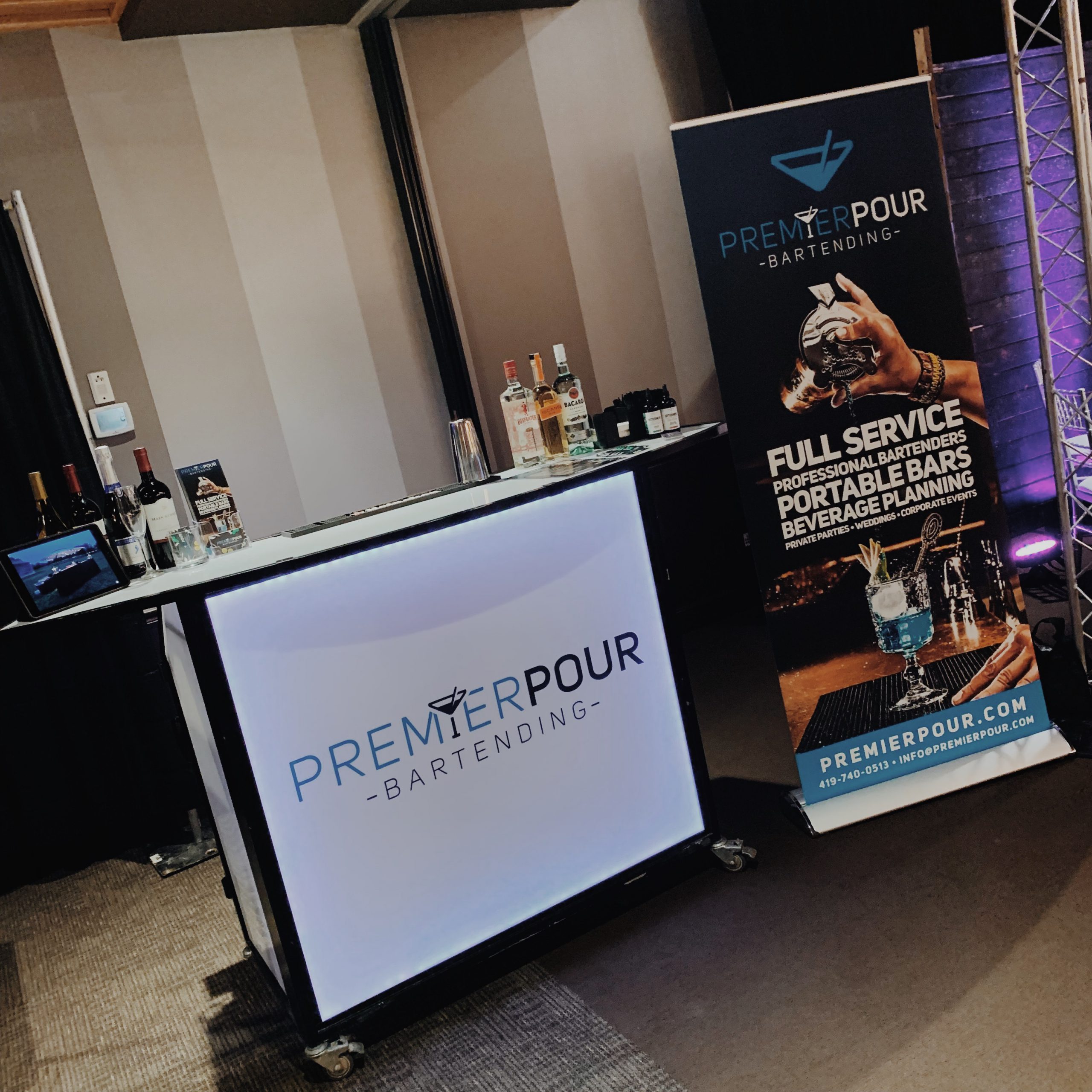 Portable bar on display with banner stand at a bridal show