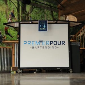 Premier Pour Bartending white mobile bar with logo set up for an event with Metroparks Toledo.