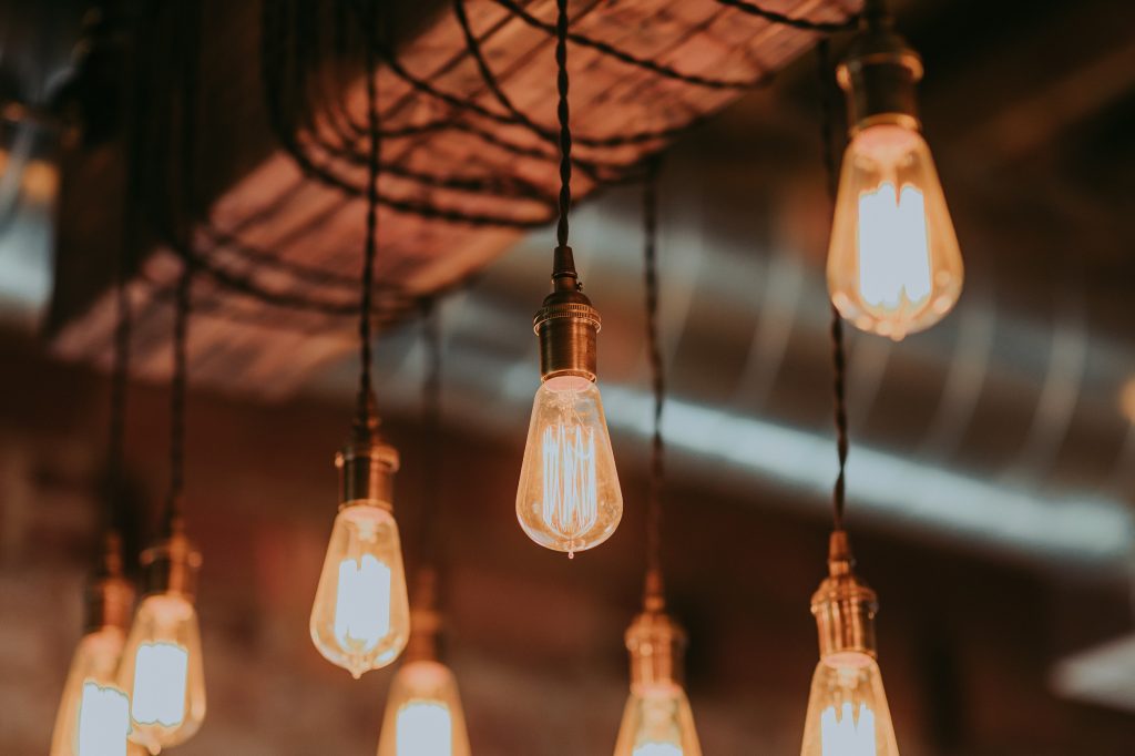 Edison bulbs hanging from a wooden beam.