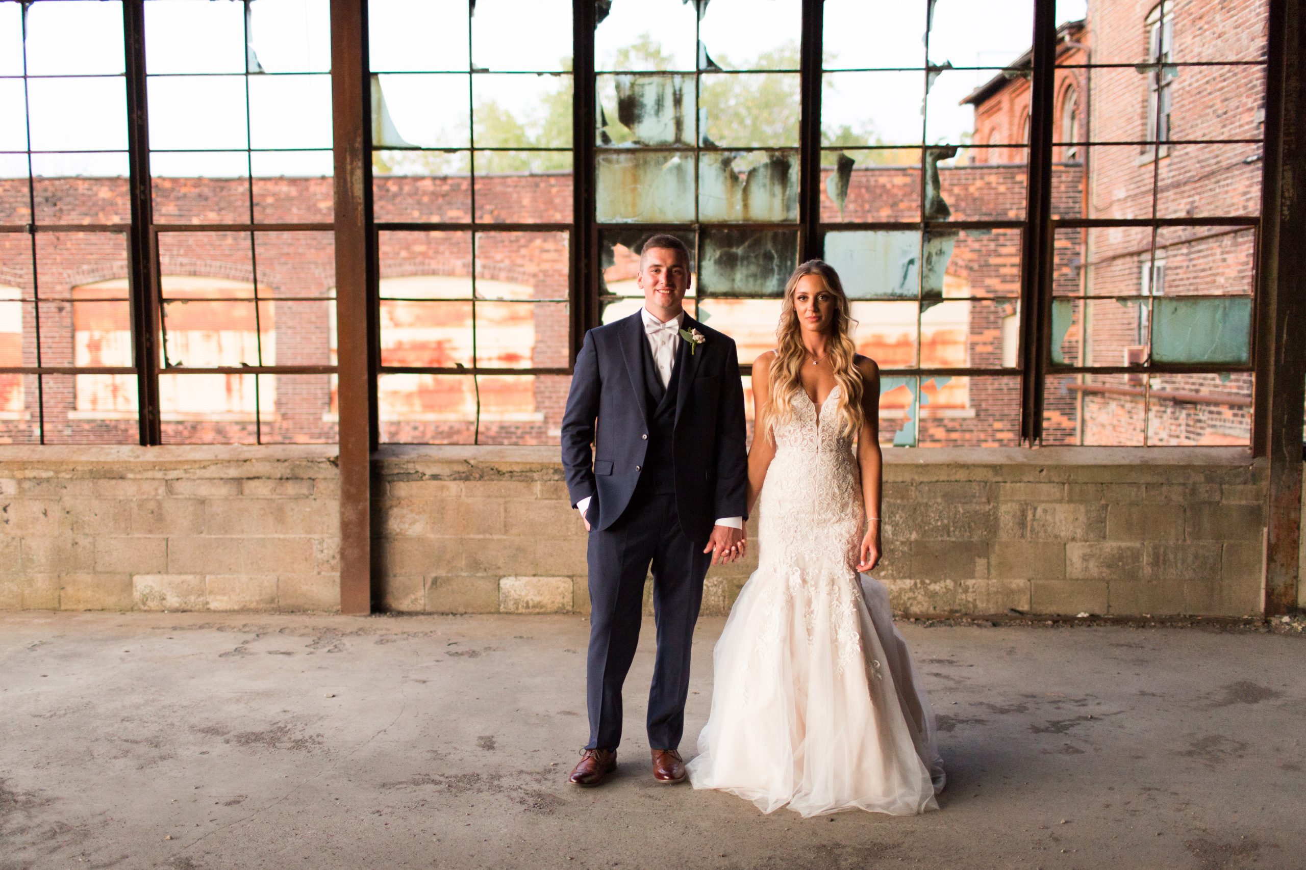 Macy and Ryan Terry posing in their wedding attire at The Venues event space in Downtown Toledo.
