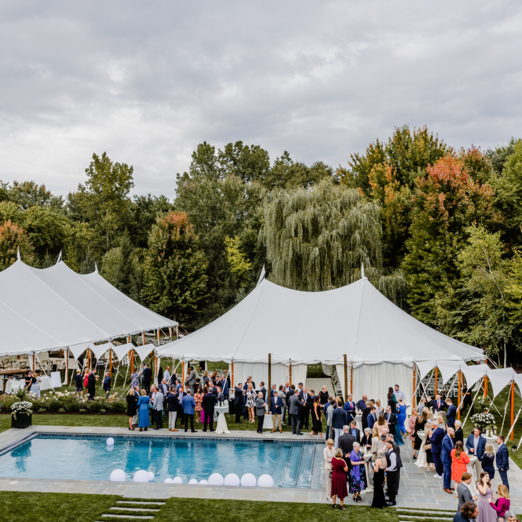 Beautiful white sailcloth tent during cocktail hour at a backyard wedding in Holland, Ohio during
