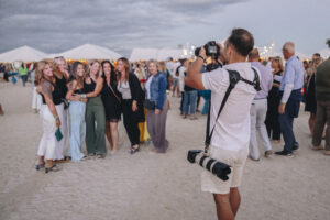 Photographer Noah Kochensparger of Green Eye Photography taking a group photo at Barefoot at the Beach