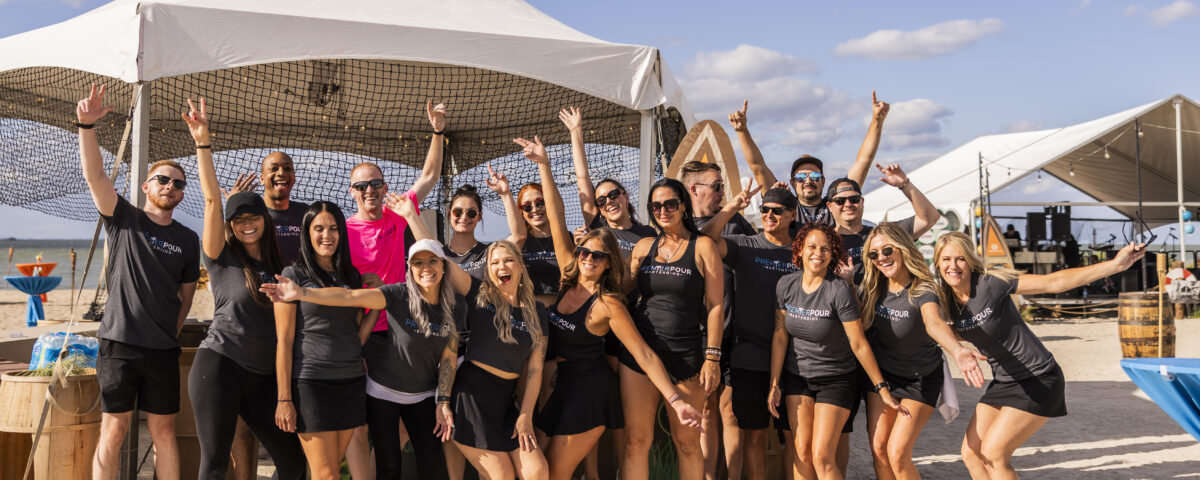 Large group of Premier Pour Bartending bartenders in a group before serving at Barefoot at the Beach