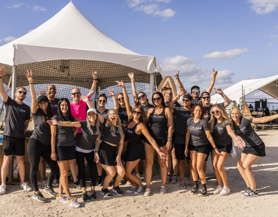 Large group of Premier Pour Bartending bartenders in a group before serving at Barefoot at the Beach