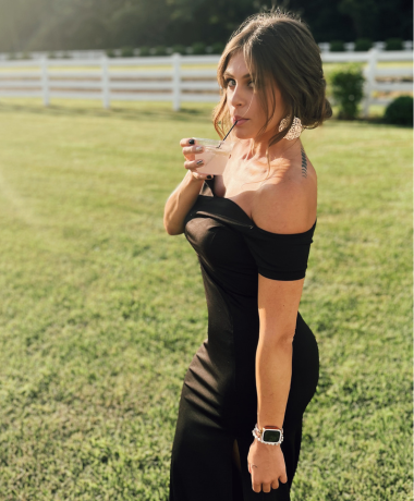 Bartender Bre Y sipping a cocktail while attending a wedding as a guest at The Stables in Whitehouse, OH